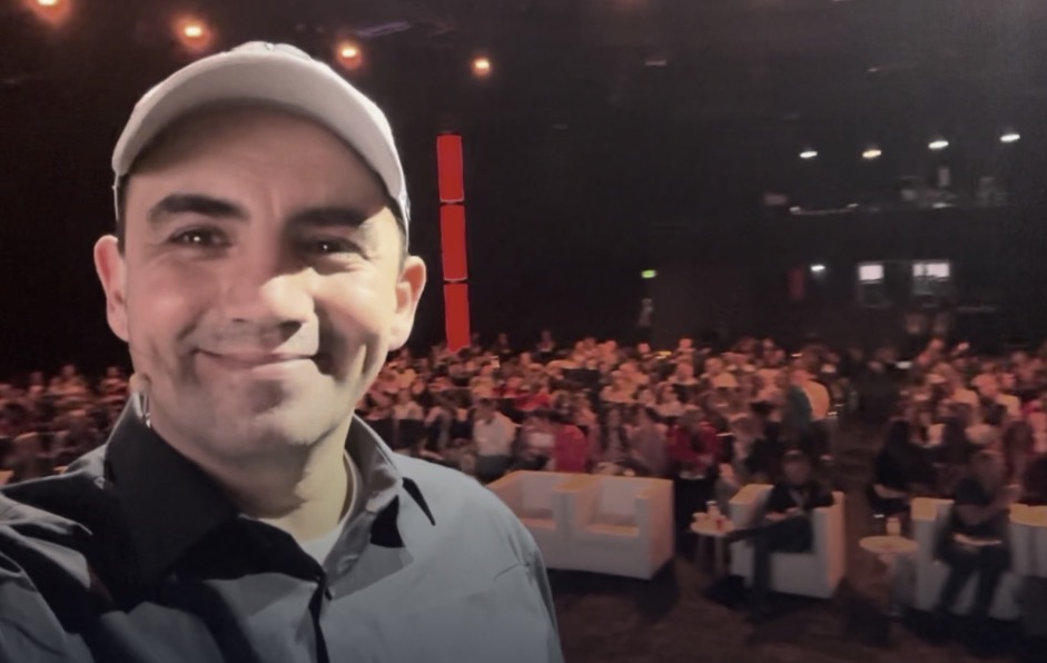 Eddie Villa on stage with a live audience